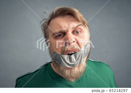 A close-up portrait of a bearded man with his 65218297