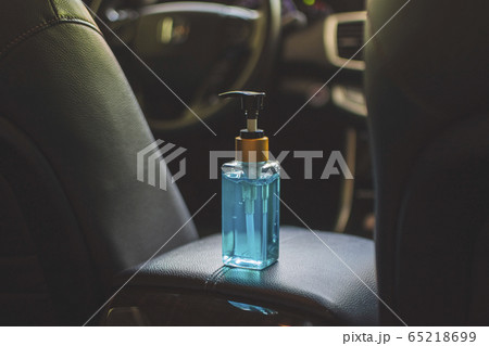 Alcohol sanitizer bottle place on leather armrest. Alcohol sanitizer bottle place on leather armrest. 65218699