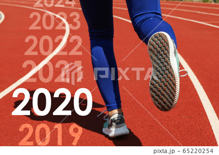 Girl running on red athletic track. Sport concept 65220254