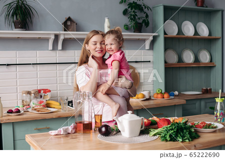 Happy beautiful mother with daughter in morning 65222690