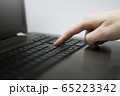 Close up photo of a man's finger pressing button 65223342