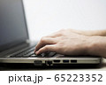 Close up photo of man's hands typing on laptop 65223352