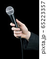 Close up of man's hand holding microphone isolated 65223357