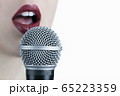 Close up of a young woman with red lips singing to 65223359