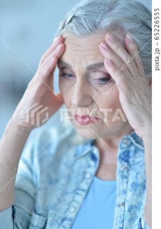 Close-up portrait of sick beautiful senior woman with headache 65226555