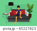 a guy playing game on sofa 65227823