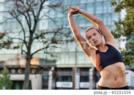 Portrait of young attractive woman stretching in 65231359