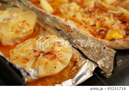 Chicken fillet with pineapples on foil and homemade Hawaiian pizza Chicken fillet with pineapples on foil and homemade Hawaiian pizza 65231718