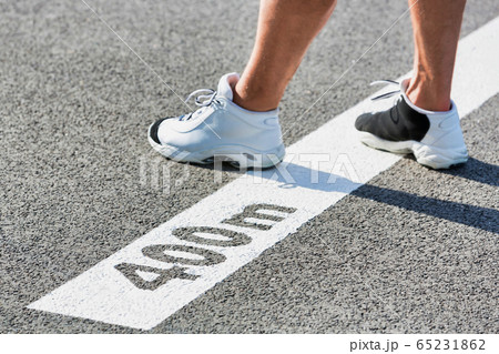 Man standing on 400 meter dash 65231862
