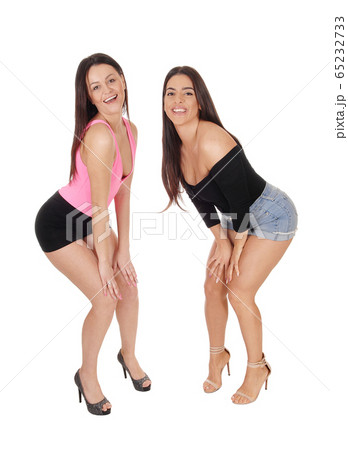 Two beautiful women standing in shorts in the 65232733