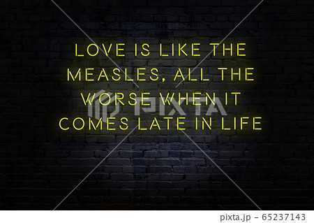 Wise quote. Neon inscription against brick wall 65237143