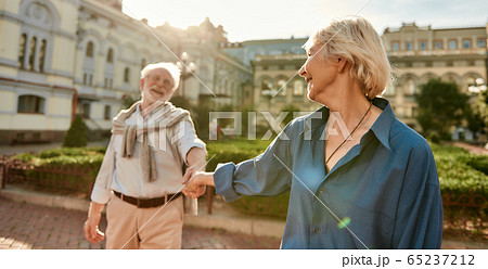 The best husband ever! Beautiful and happy senior couple holding hands and smiling while spending time together outdoors The best husband ever! Beautiful and happy senior couple holding hands and smiling while spending time together outdoors 65237212