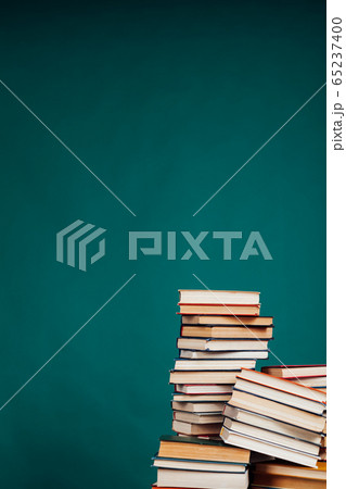 a lot of educational books for exams at the university on the green background of the library 65237400