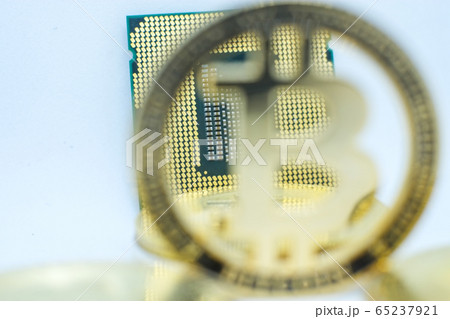 Closeup of physical bitcoin and computer cpu processor Closeup of physical bitcoin and computer cpu processor 65237921