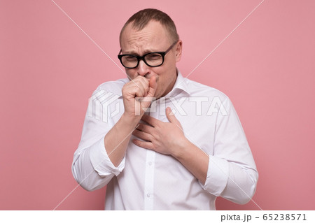 Mature caucasian man coughing because of flu or grippe Mature caucasian man coughing because of flu or grippe 65238571