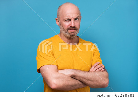 mature man looking with mistrust does not believe in news mature man looking with mistrust does not believe in news 65238581