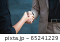 Two confident business man shaking hands during a 65241229