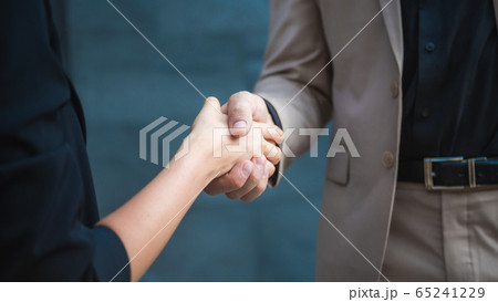 Two confident business man shaking hands during a 65241229