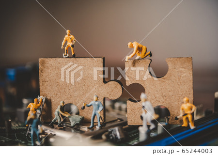Miniature people or small figure worker on puzzles 65244003