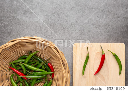 Pepper of thailand in the wooden basket and on the wooden cutting board Pepper of thailand in the wooden basket and on the wooden cutting board 65246109