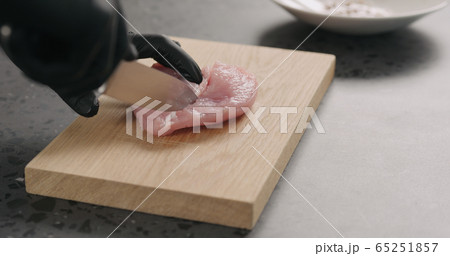 man hands trim turkey fillet on oak board man hands trim turkey fillet on oak board 65251857