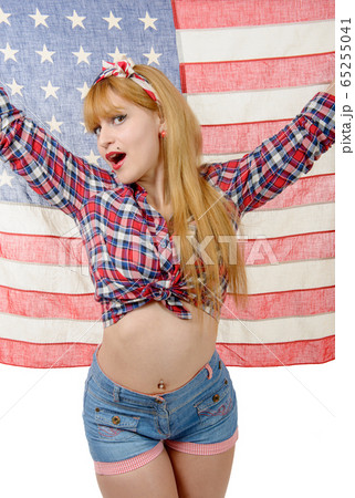 Sexy pin up girl isolated holding an American Flag 65255041