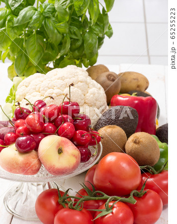 cherries and peaches cup with some vegetables 65255223