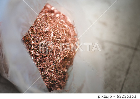 Copper scrap materials recycling. Copper chip waste after machining metal parts on a cnc lathe. 65255353