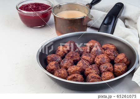 Meatballs served with cream sauce and cranberry Meatballs served with cream sauce and cranberry 65261075