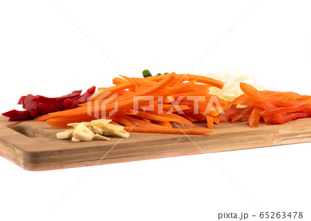 Sliced onions, garlic, carrots, sweet peppers on a cutting board. 65263478