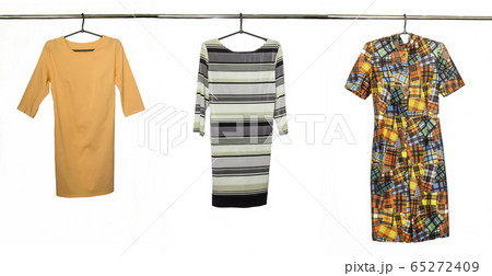 A collection of elegant dresses, isolated on white background. Photo on the crossbar and shoulders 65272409