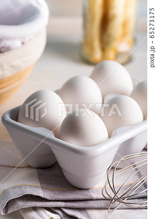 Ceramic container with natural organic farm eggs on a blurred kitchen background. 65273175