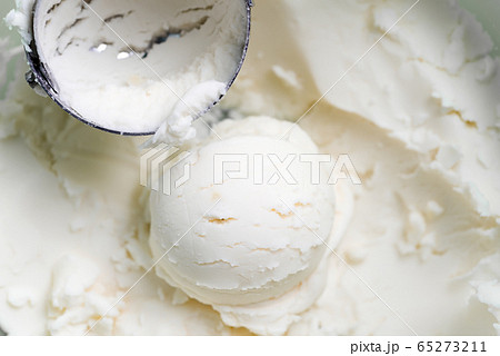 Vanilla natural ice-cream scooped out from container with freshly cooked dessert. 65273211