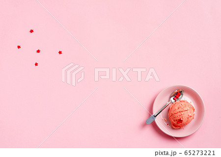 Ball of homemade natural fresh berries ice-cream and metallic spoon on a pink plate on a pink pastel background Ball of homemade natural fresh berries ice-cream and metallic spoon on a pink plate on a pink pastel background 65273221