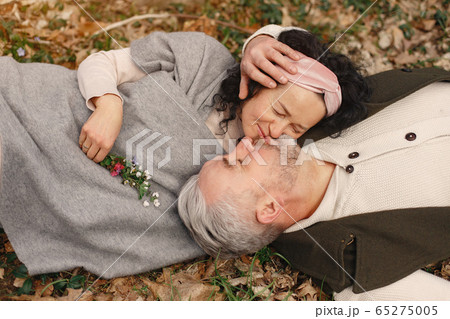 Elegant adult couple in a spring forest 65275005