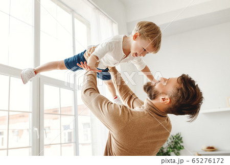 Happy man with little son having fun at home 65276172