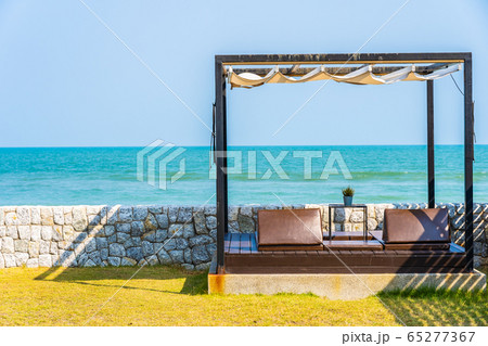 Pillow on sofa bed with lounge around beach ocean sea and blue sky Pillow on sofa bed with lounge around beach ocean sea and blue sky 65277367