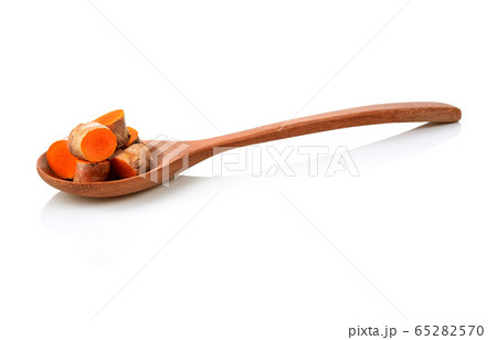 Turmeric in a wooden spoon on a white background 65282570