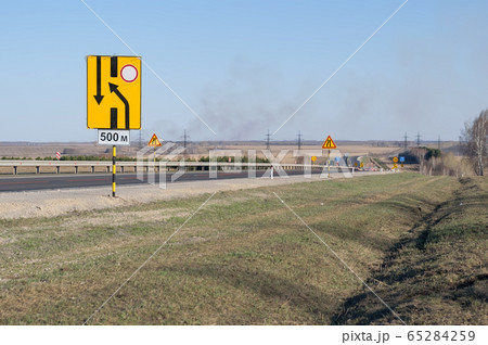 many signs about road repairs on a country highway many signs about road repairs on a country highway 65284259