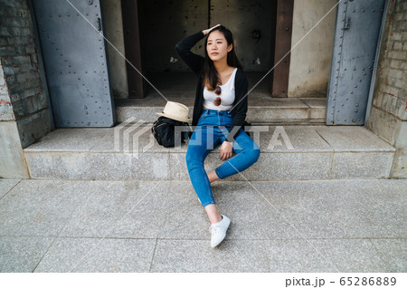 Young stylish woman in jeans and black light Young stylish woman in jeans and black light 65286889