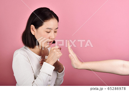 Asian woman have sore throat allergy and coughing, Sneezing and coughing in public place 65286978