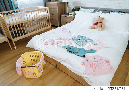 view of master bedroom with some baby clothes 65288721