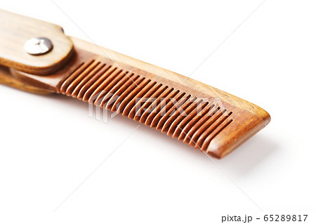 Sandalwood comb on a white background. Hair care. Sandalwood comb on a white background. Hair care. 65289817