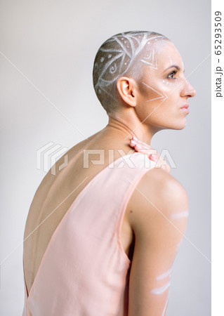 Sensual woman with painted head against gray Sensual woman with painted head against gray 65293509