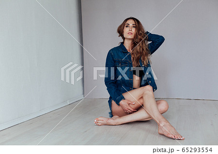 Portrait of a beautiful fashionable woman in black lingerie and denim shorts Portrait of a beautiful fashionable woman in black lingerie and denim shorts 65293554