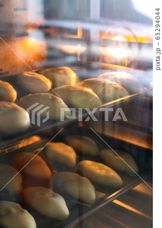 Raw pies on pan sheets in oven 65294044