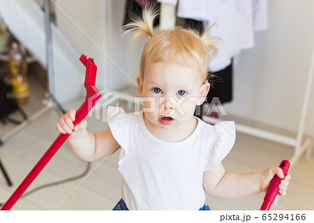 Baby girl wearing a hearing aid. Disabled child, disability and deafness concept. Baby girl wearing a hearing aid. Disabled child, disability and deafness concept. 65294166