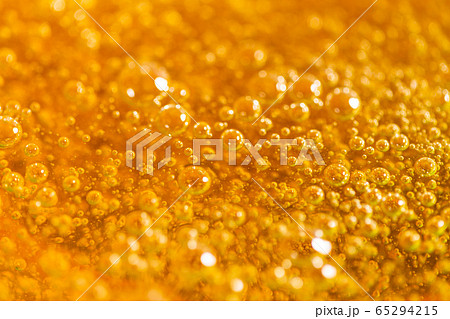 Detail of abstract orange bubble, can be used for background. Paste for sugaring close-up. Depilation and hair removal concept. Macro photo. Detail of abstract orange bubble, can be used for background. Paste for sugaring close-up. Depilation and hair removal concept. Macro photo. 65294215