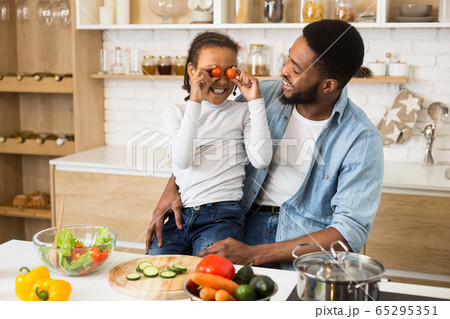 Funny dad and daughter having good time at kitchen 65295351