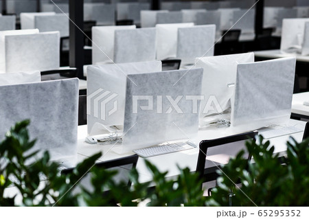 Big office with covered computers with no workers 65295352